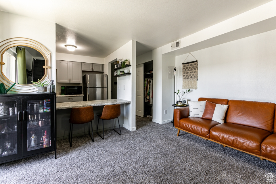 Living room featuring carpet and beverage cooler