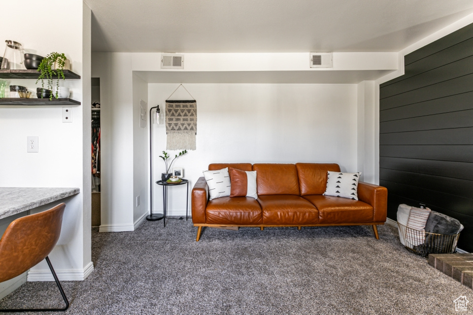 Living room featuring dark colored carpet