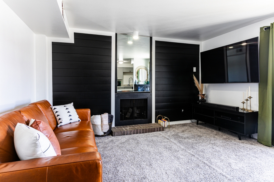 Carpeted living room with a fireplace