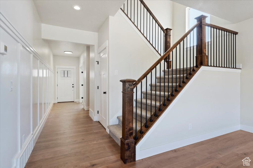 Staircase with hardwood / wood-style flooring