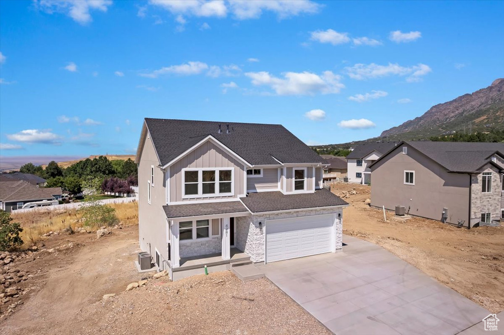 View of front facade with a mountain view and a garage