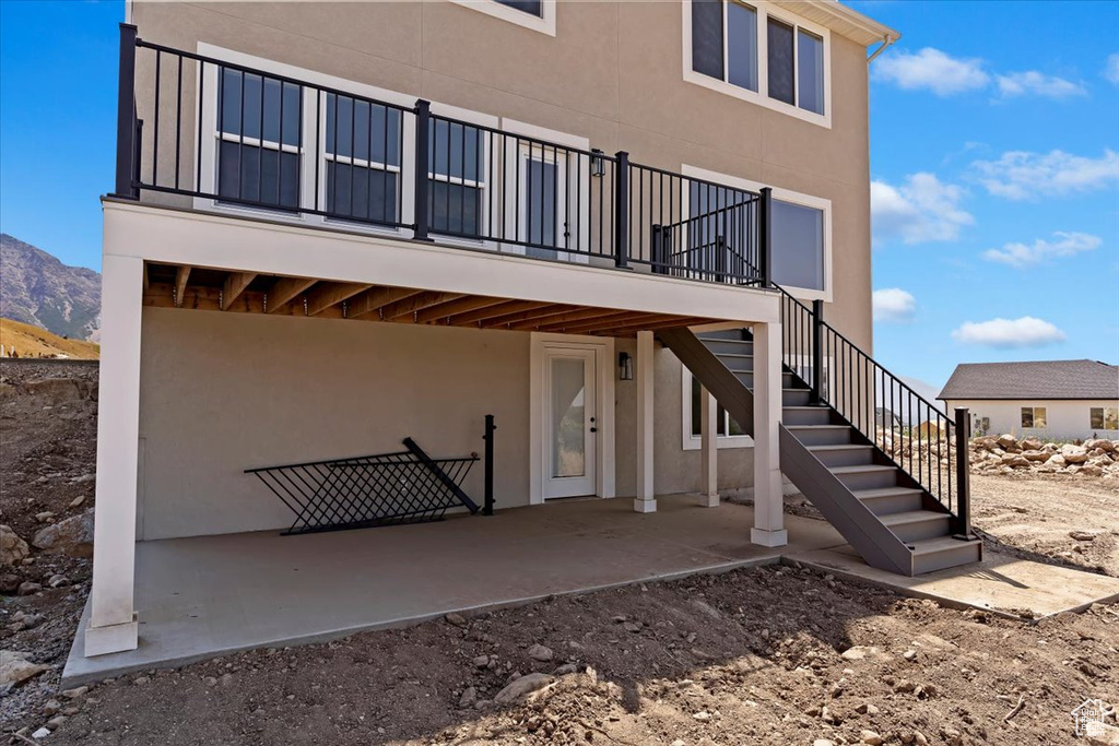 Rear view of house with a patio and a mountain view