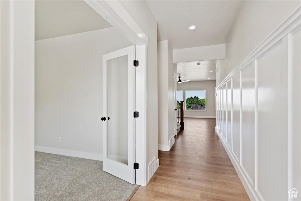 Corridor featuring light hardwood / wood-style flooring