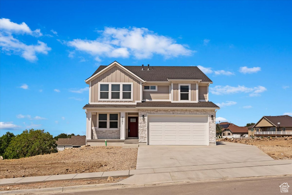 View of front of property featuring a garage