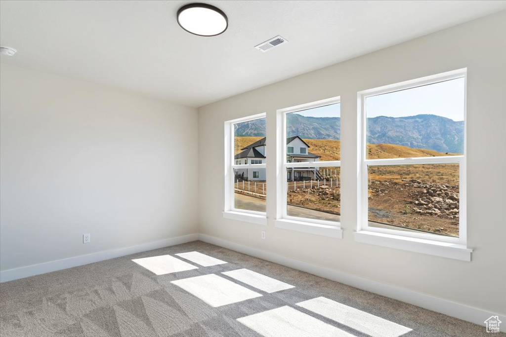 Carpeted empty room with a mountain view