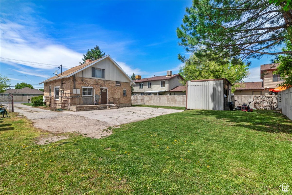 View of yard with a patio and a shed