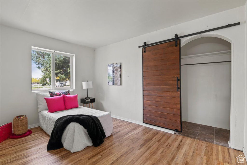 Tiled bedroom with a barn door