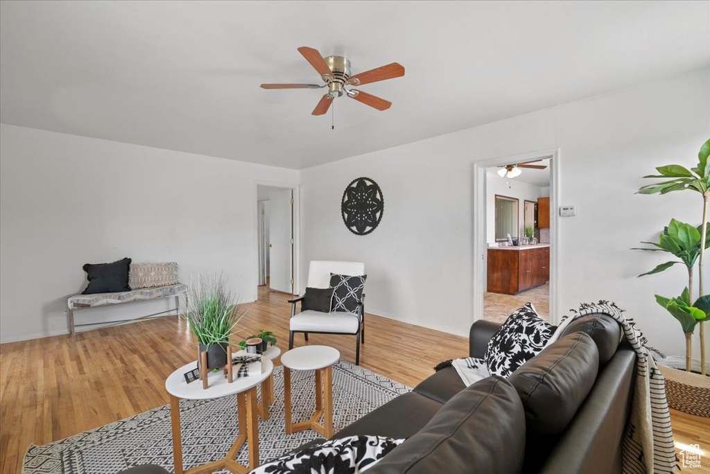 Living room featuring hardwood / wood-style floors and ceiling fan