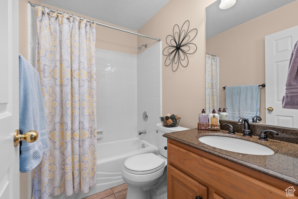 Full bathroom with tile flooring, vanity, toilet, and shower / tub combo