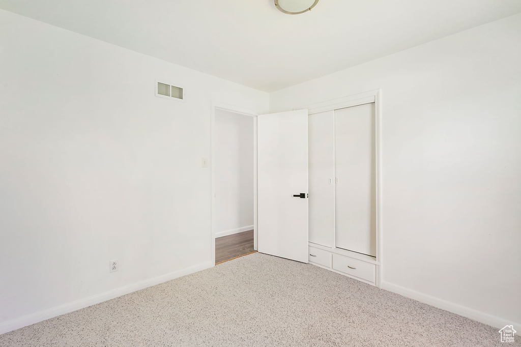 Unfurnished bedroom featuring carpet and a closet