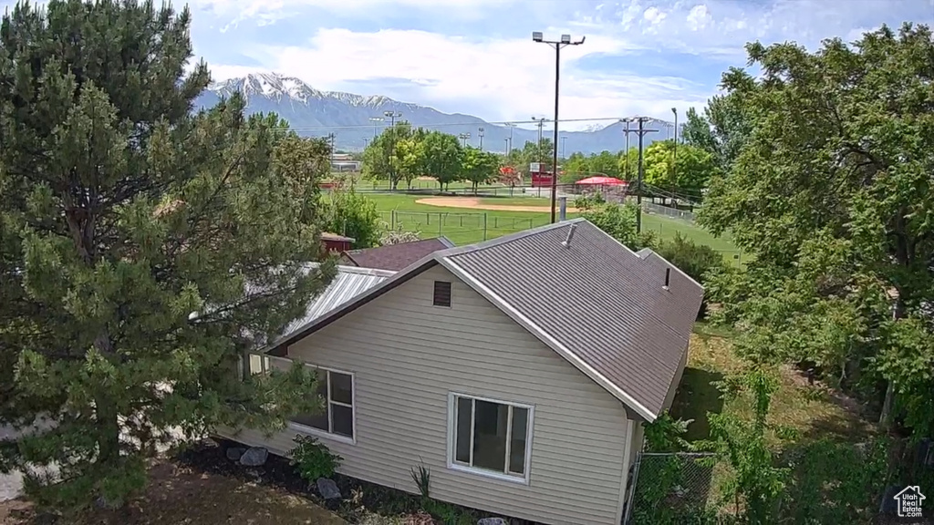 Exterior space featuring a mountain view and a yard