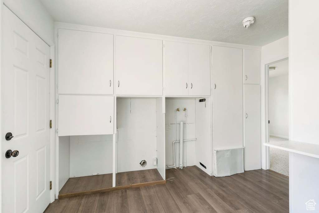 Laundry area with hardwood / wood-style floors