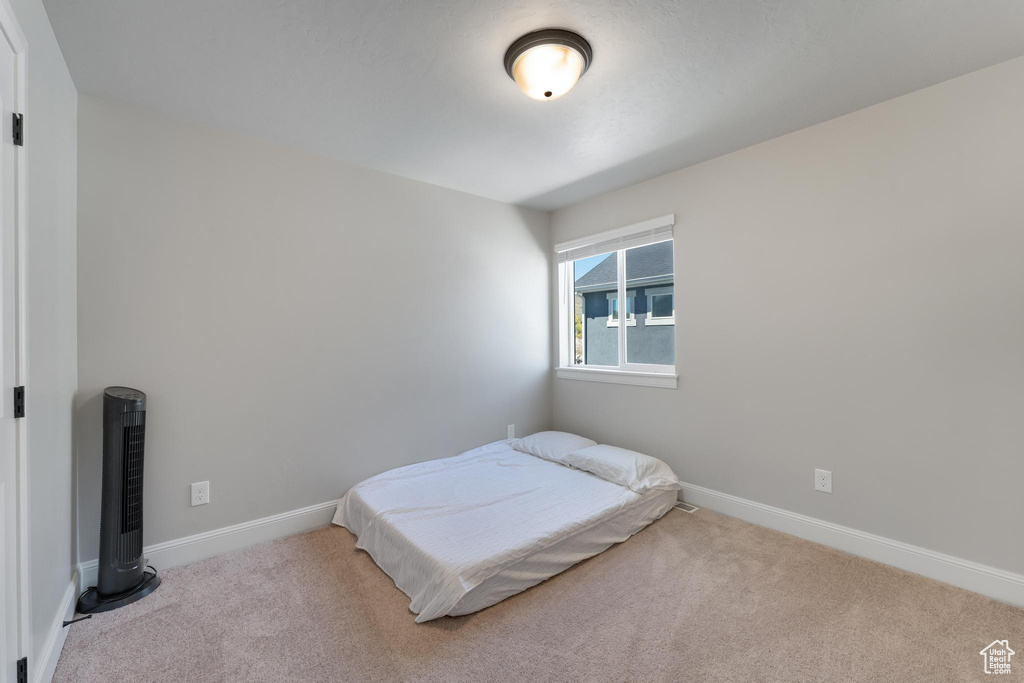 Bedroom with light colored carpet