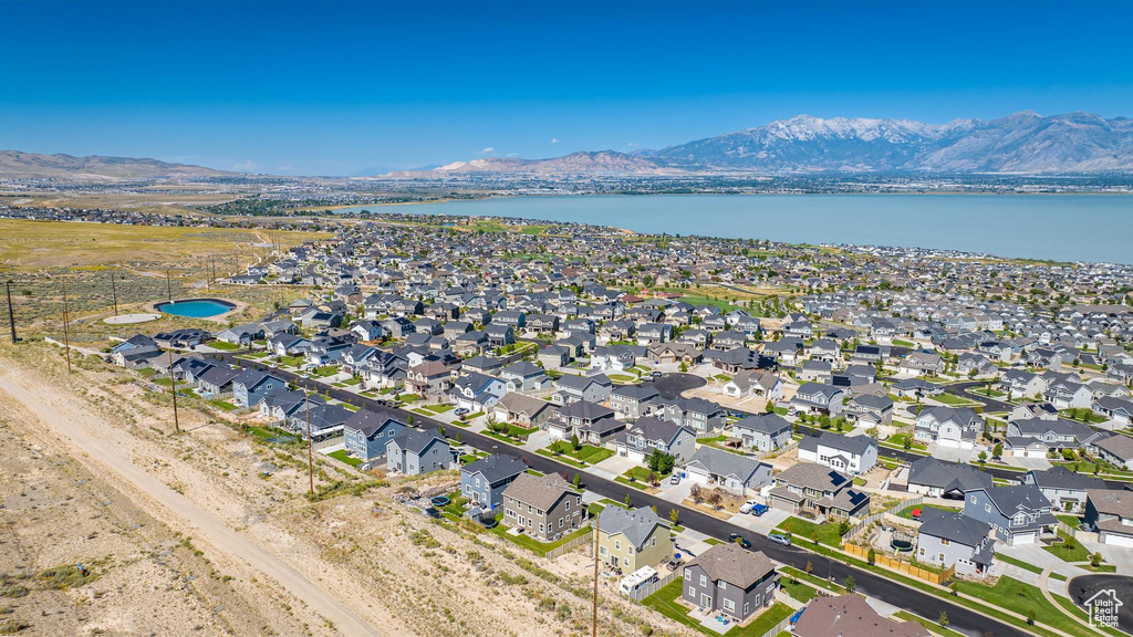 Birds eye view of property featuring a water and mountain view