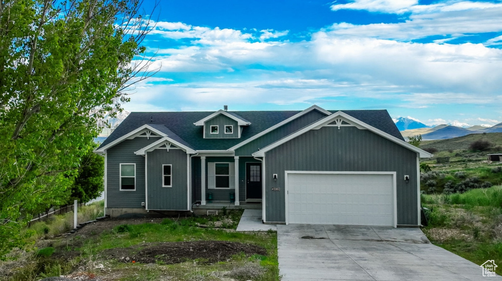 View of front of home featuring a garage and a mountain view