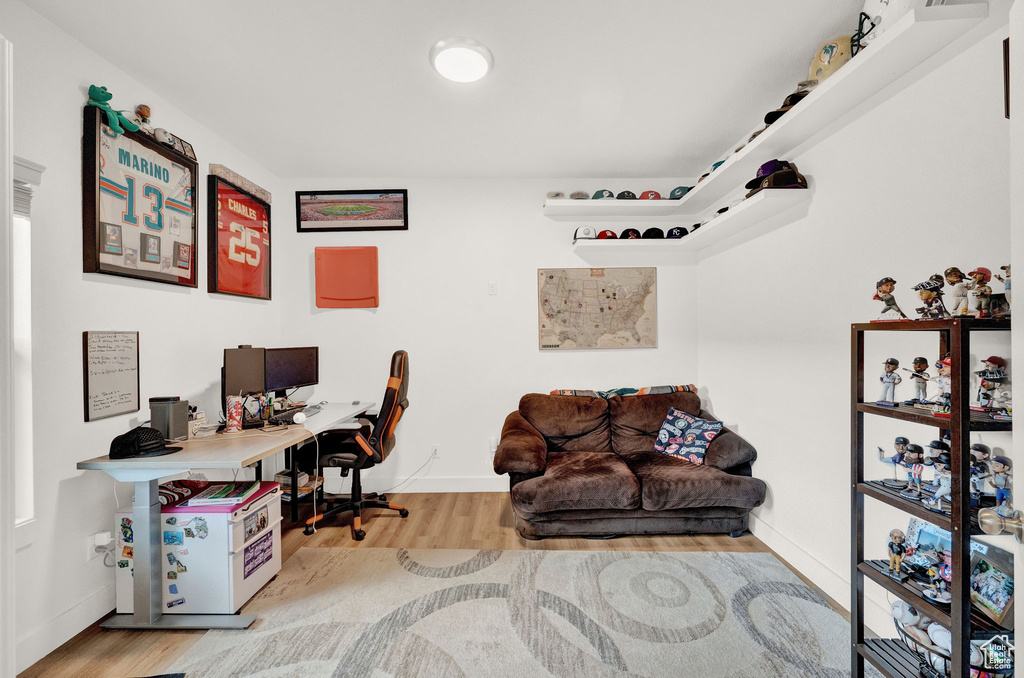 Home office with wood-type flooring