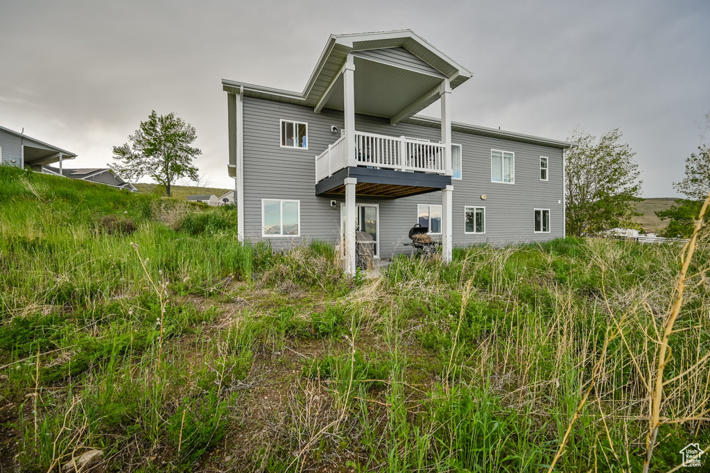 Rear view of property with a balcony