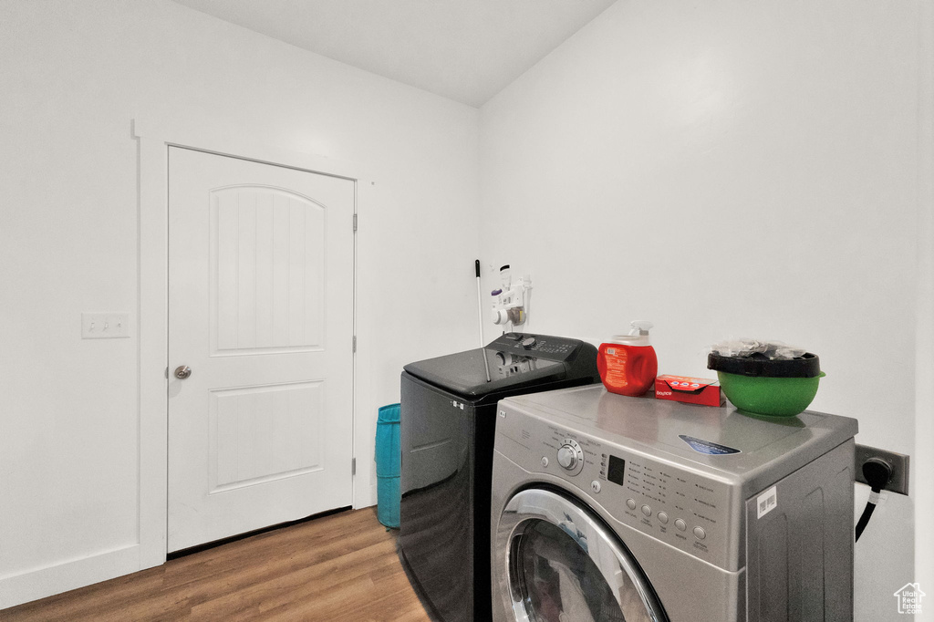 Laundry room featuring light hardwood / wood-style floors, washing machine and clothes dryer, and hookup for an electric dryer