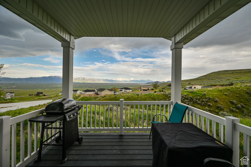 Wooden terrace with a mountain view and area for grilling