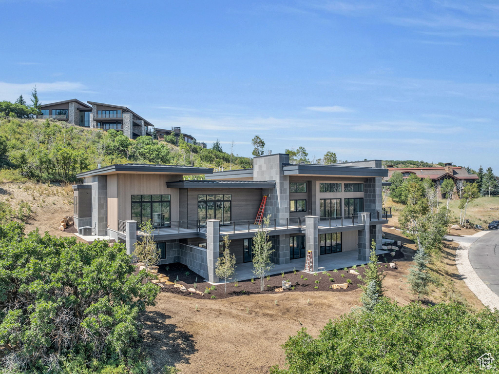 Back of house with a balcony