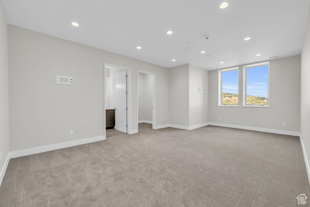 Unfurnished bedroom featuring light carpet