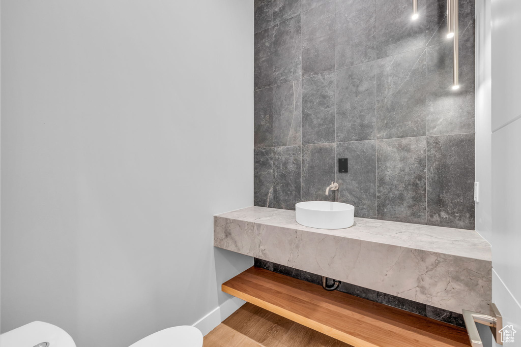 Bathroom featuring wood-type flooring and toilet