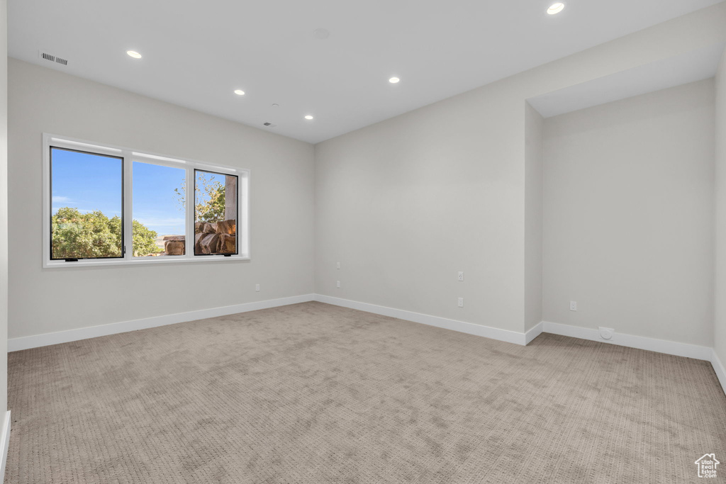 Empty room featuring light carpet