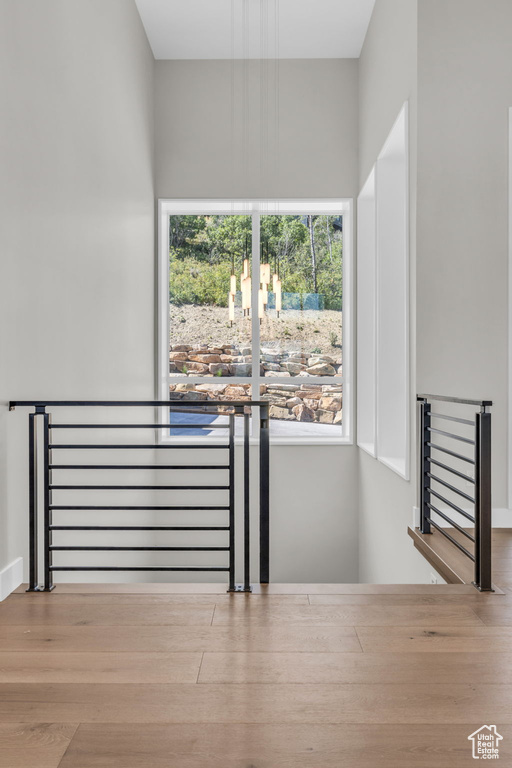 Staircase with light hardwood / wood-style flooring