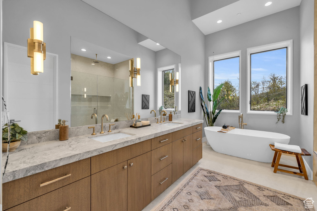 Bathroom with separate shower and tub and dual bowl vanity