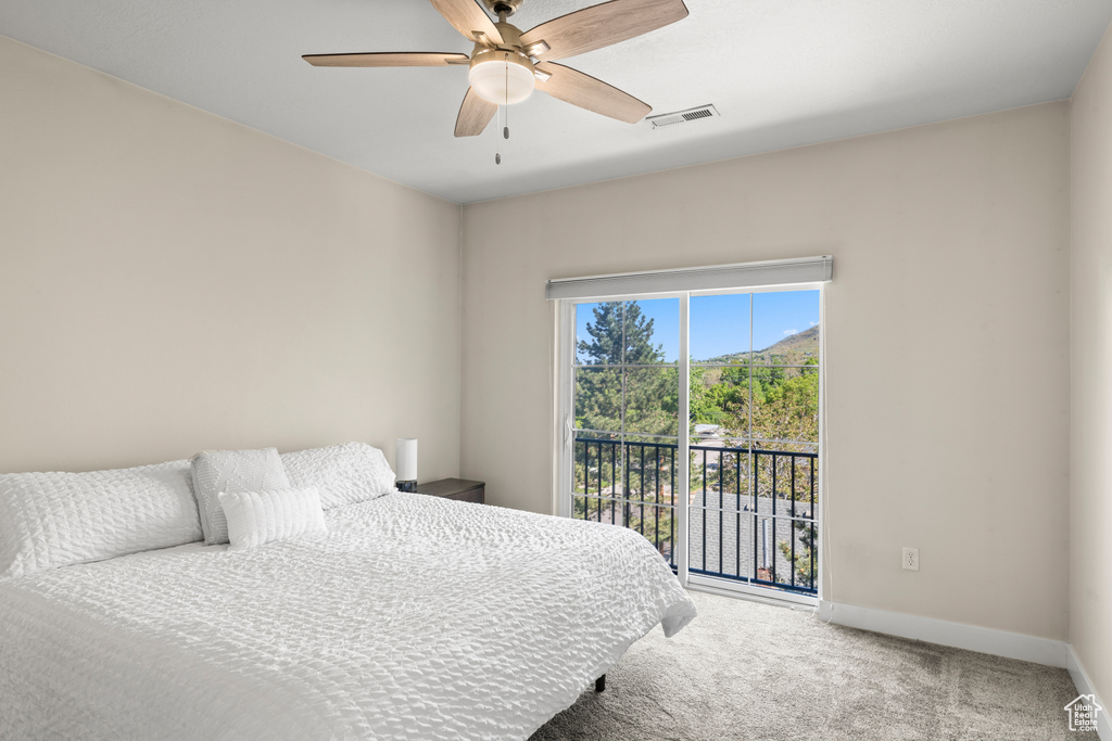 Bedroom featuring ceiling fan, carpet floors, and access to exterior