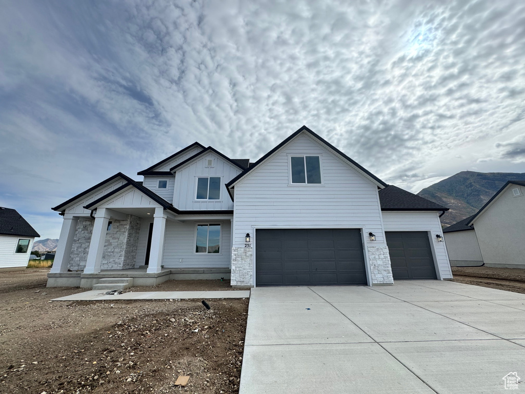 View of front of house with a garage and covered porch