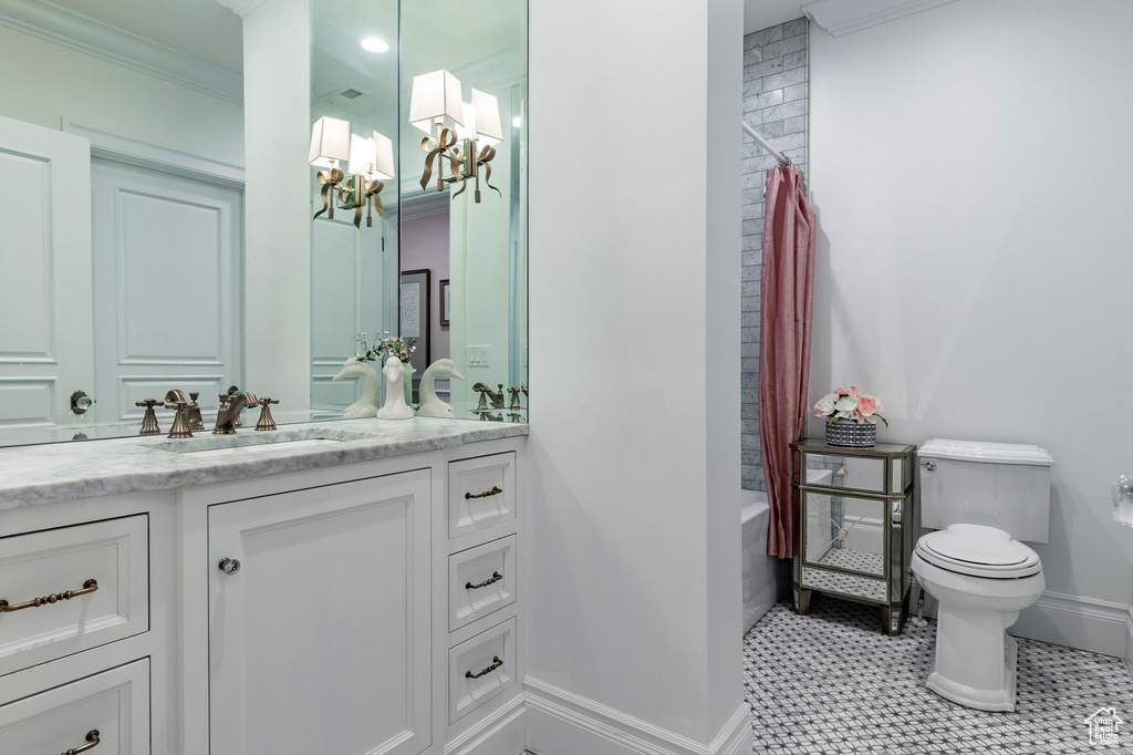 Full bathroom with shower / bathtub combination with curtain, tile floors, ornamental molding, toilet, and vanity