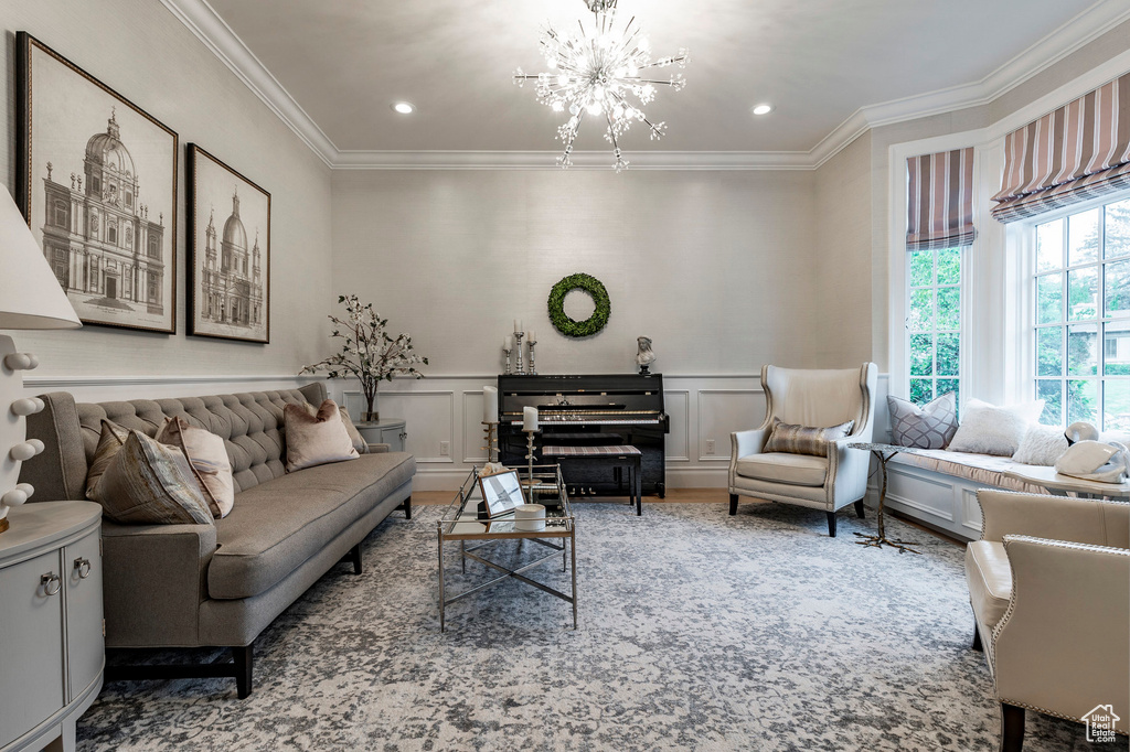 Living room with a notable chandelier and ornamental molding