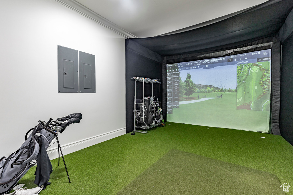 Rec room featuring golf simulator, ornamental molding, and carpet floors