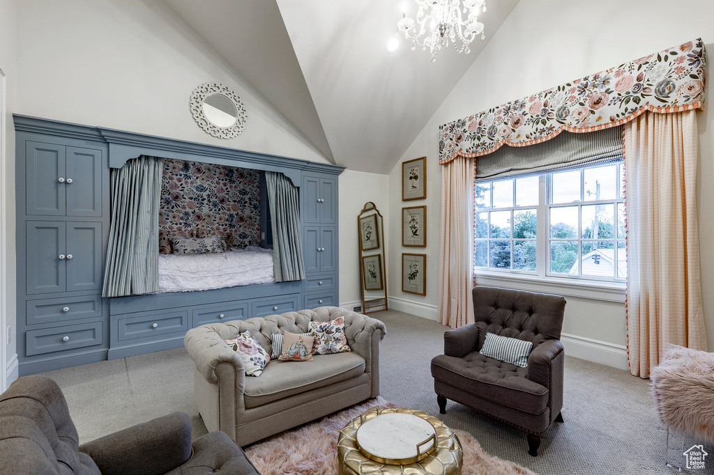 Living room featuring a notable chandelier, high vaulted ceiling, and carpet