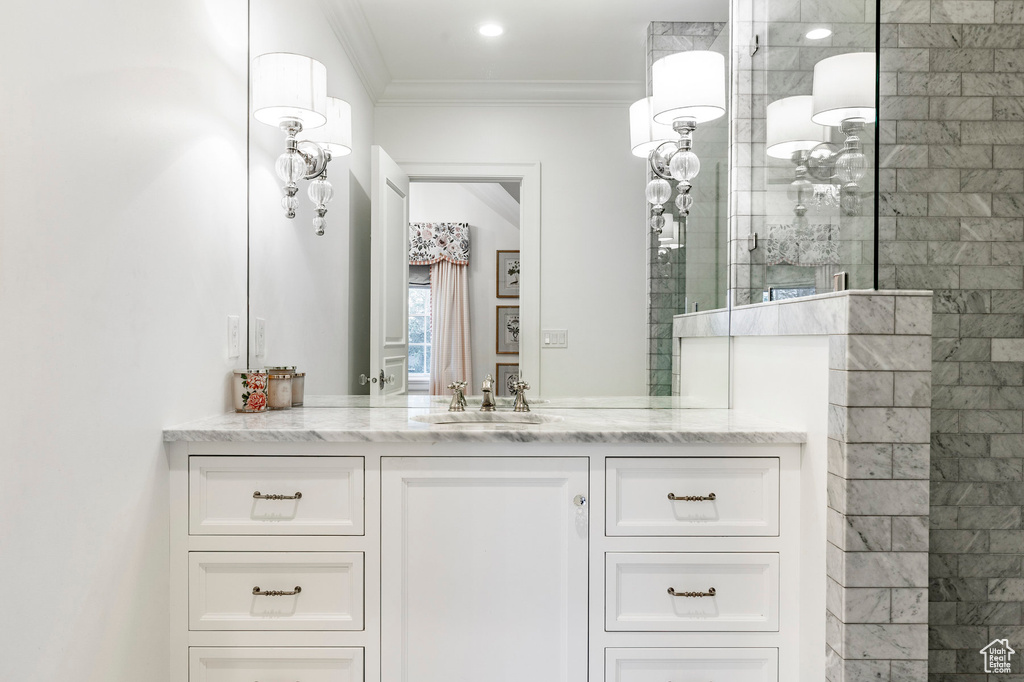 Bathroom featuring crown molding and vanity