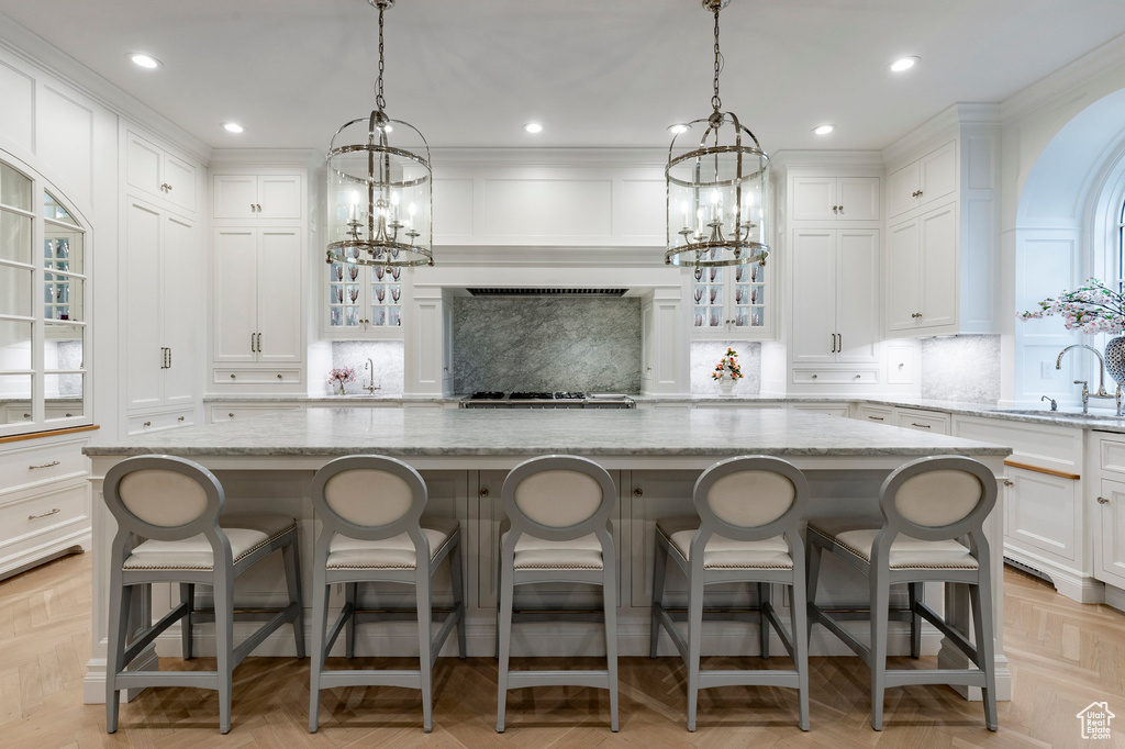 Kitchen with a center island, backsplash, and light parquet flooring