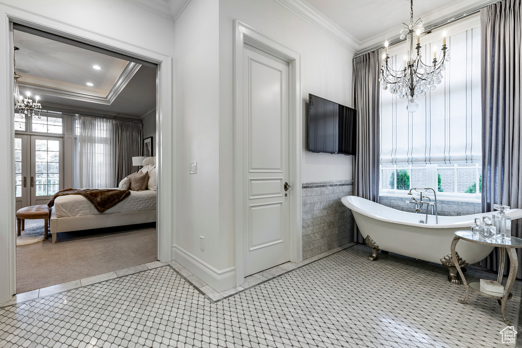 Bathroom featuring a notable chandelier, tile flooring, and ornamental molding