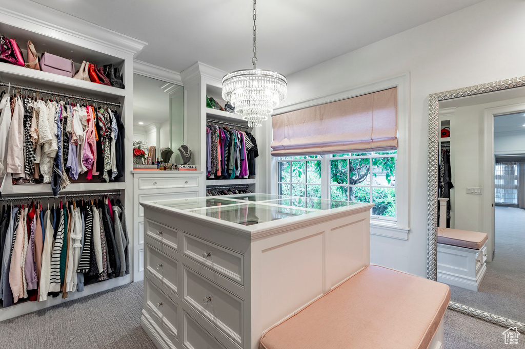 Walk in closet featuring carpet flooring and a chandelier