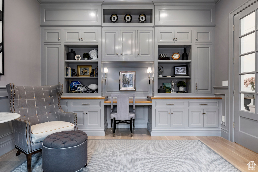 Interior space with built in desk and light wood-type flooring