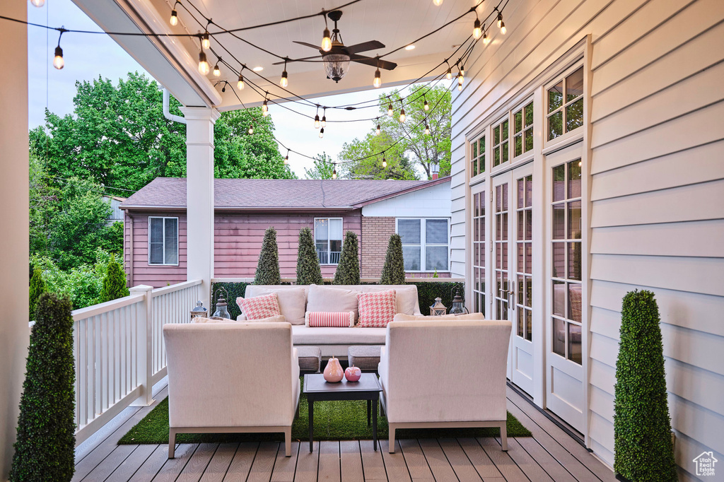 Wooden terrace featuring an outdoor hangout area and ceiling fan