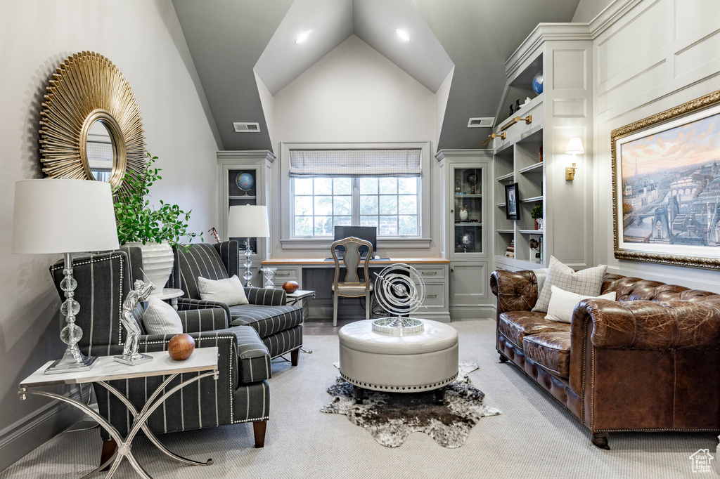 Living room with vaulted ceiling and light carpet