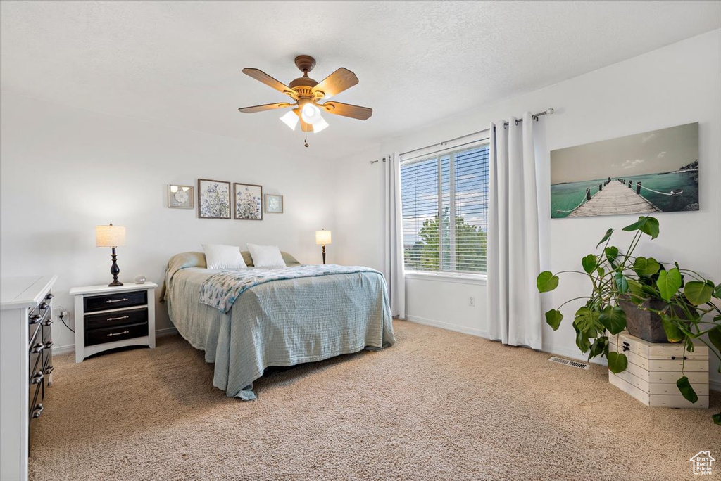 Bedroom featuring ceiling fan and light colored carpet