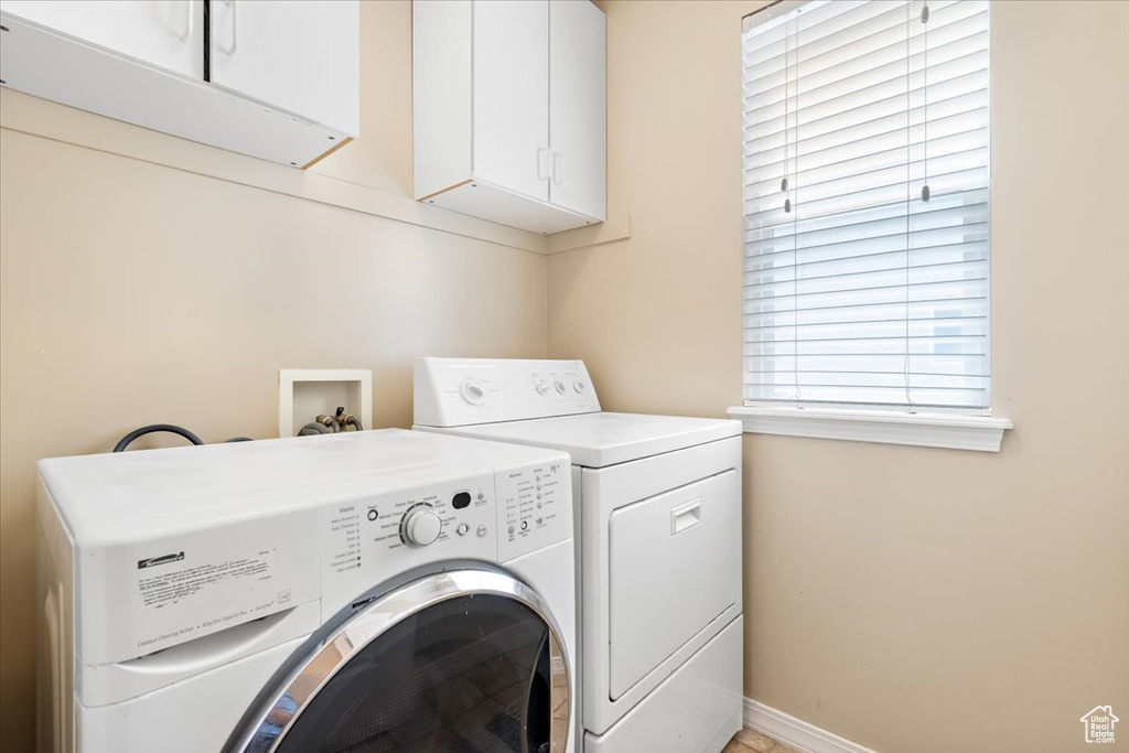 Clothes washing area with cabinets, washing machine and dryer, and hookup for a washing machine