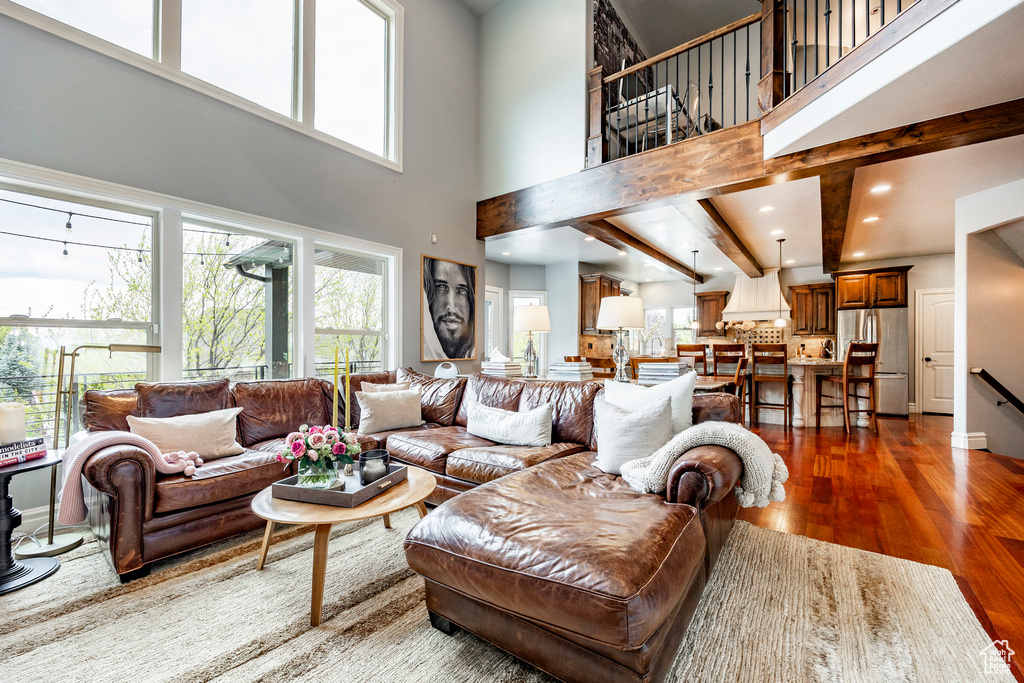 Living room with a high ceiling and wood-type flooring