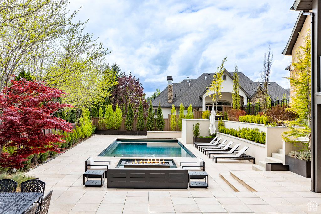 View of pool featuring a jacuzzi and a patio area