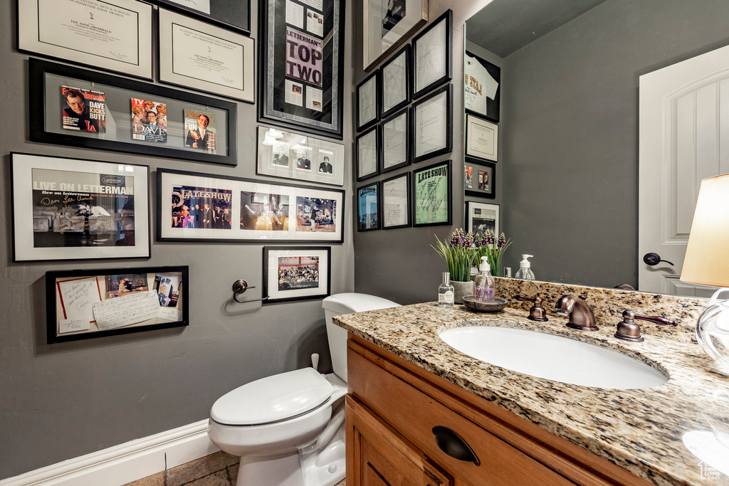 Bathroom with tile floors, oversized vanity, and toilet