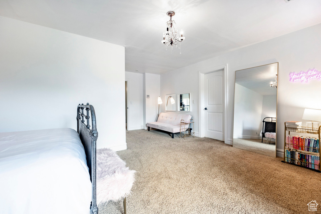 Carpeted bedroom featuring a chandelier