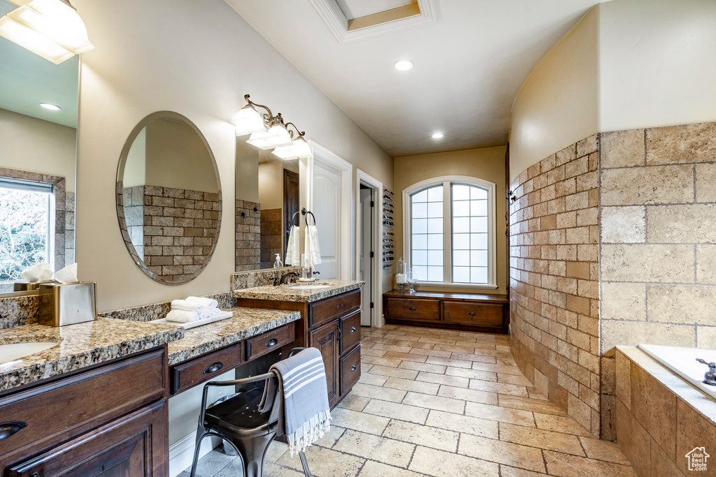 Bathroom with tile floors, plenty of natural light, and vanity