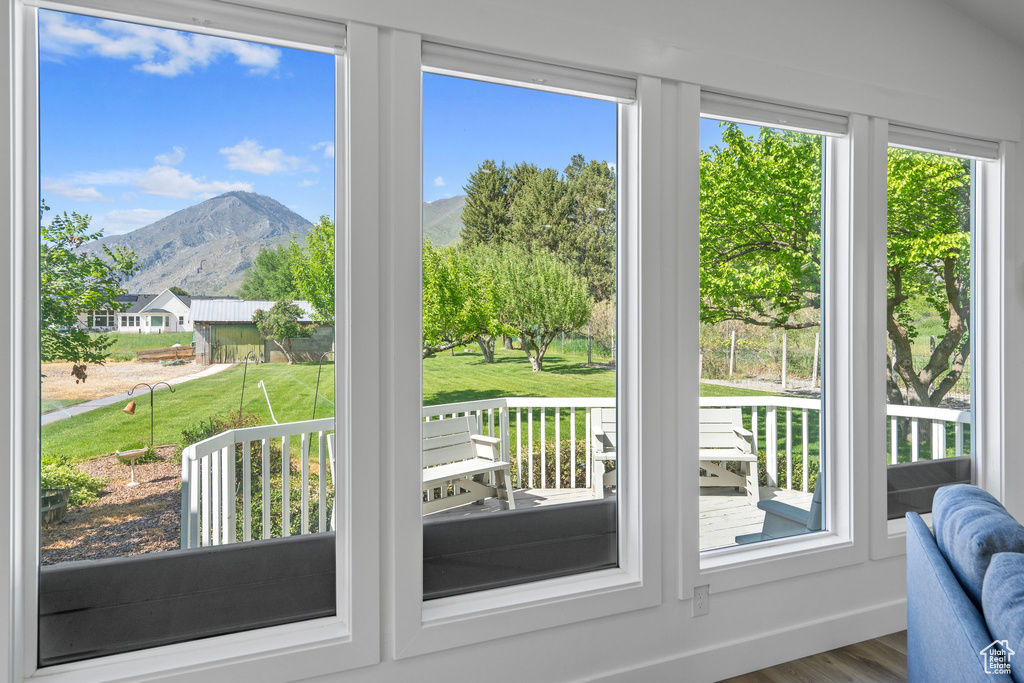 Doorway to outside with a mountain view and hardwood / wood-style flooring